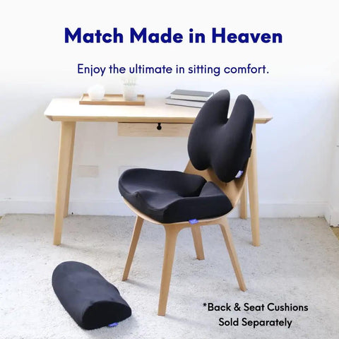 Office chair with black ergonomic back cushion and under desk foot rest.