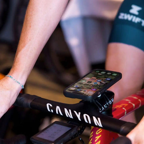 Bike Handlebar And Stem Phone Mount Kit With MAG Universal Adapter And Dual Lock on racing bike displaying mounted smartphone.