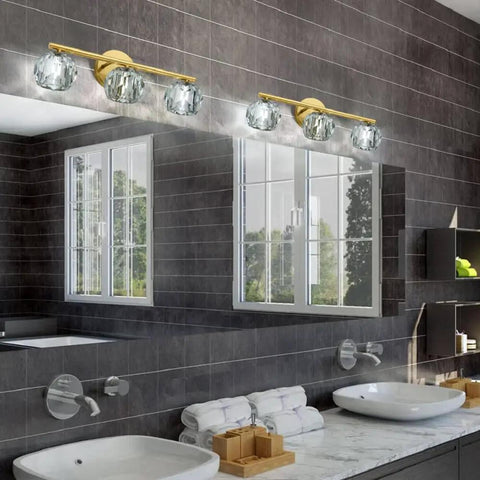 Three Light Gold Brass Vanity Light Fixture With Clear K9 Crystal Glass over bathroom mirror, modern wall sconce view