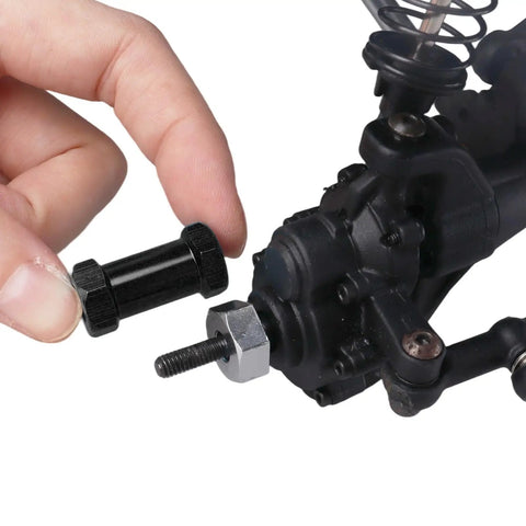 Hand holding 4 Pack Aluminum RC Wheel Spacers 12mm Hex With 25mm Offset Extension For 1 Tenth Scale Crawlers, black spacer detail