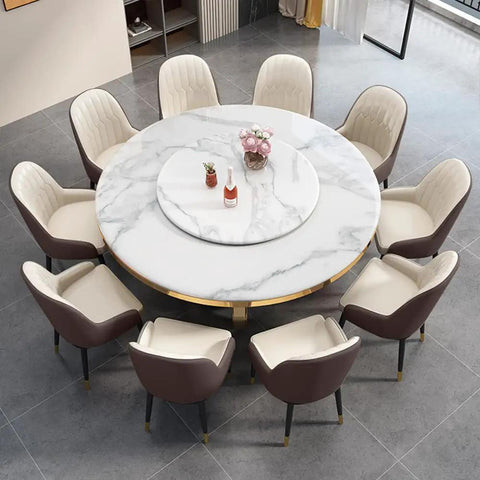 Kickback Ready Round Marble Dining Table Built For Epic Weekend Hangouts Featuring A Smooth White Spinning Lazy Susan And Bold Gold Stainless Steel Base Stretching Fifty Nine Inches Wide with plush chairs.