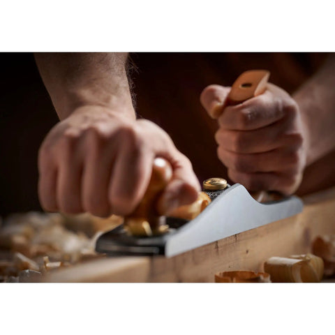 Close-up of hands using Low Angle Jack Plane, Sweetheart No 64 Style, Old School Pro Hand Tool for flattening wood, showing precise shaves.