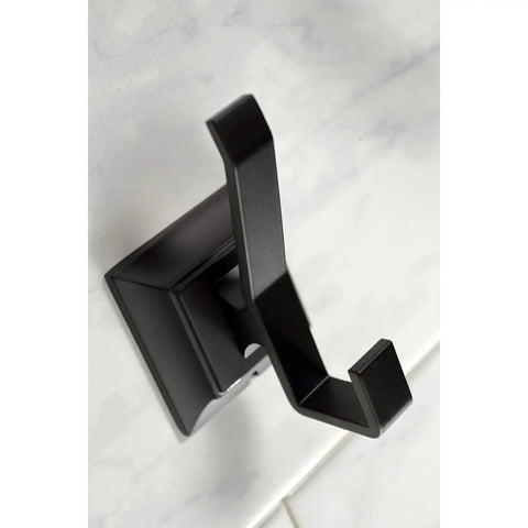Close-up of robe hook from Monarch 5 Piece Bath Accessory Set in Matte Black, mounted on marble wall.
