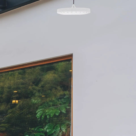 LED Camping Lantern Round Waterproof Portable Tent Light for Hiking and Emergencies hanging in modern patio area.