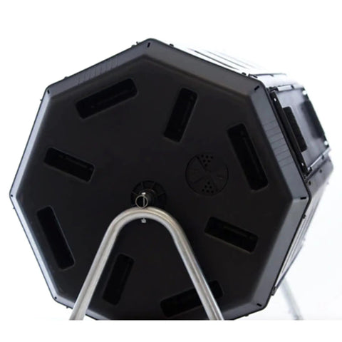 Close-up of a black Dual Chamber Tumbling Compost Bin With Wheels, 37 Gallon Outdoor Garden Recycler, elevated rotating design.