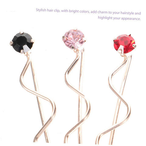 Stylish hair clip featuring black, pink, and red stones on a wavy gold base, perfect for enhancing hairstyles.