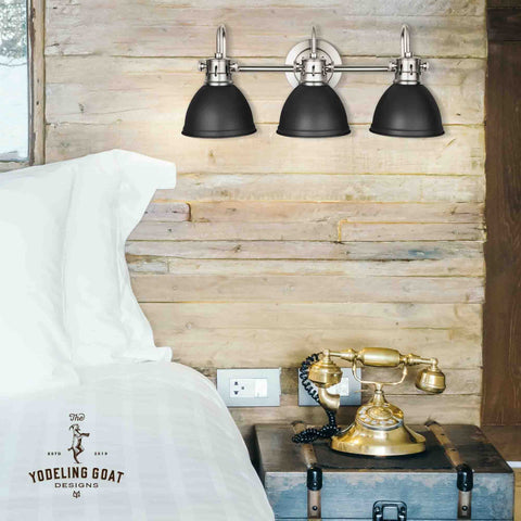 Black Vanity Light With Three Fixtures For Farmhouse Bathroom Over Mirror Rustic Vintage Style Wall Lights above a bed in rustic setting