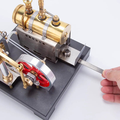 Hands adjusting Hands On Steam Engine Model Kit With Boiler For DIY Projects, Metal Beam Engine Build For Tinkerers