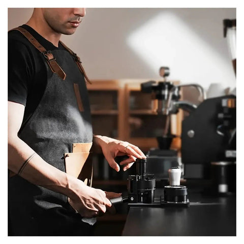 Man using Top Shelf Espresso Needle Wdt Tool For 58mm Portafilter Black coffee ground stirrer on a counter.