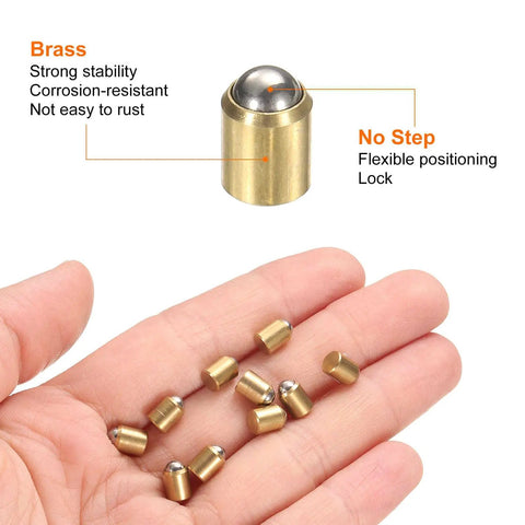 Close-up of brass ball spring plungers in hand, showcasing 30 Piece Pack Top Shelf Brass Ball Spring Plungers 5Mm X 6Mm No Step Detents Heavy Duty Cabinet Latches Smooth Ride Locks Killer Grip Hardware For Furniture Doors And Workshop Builds.