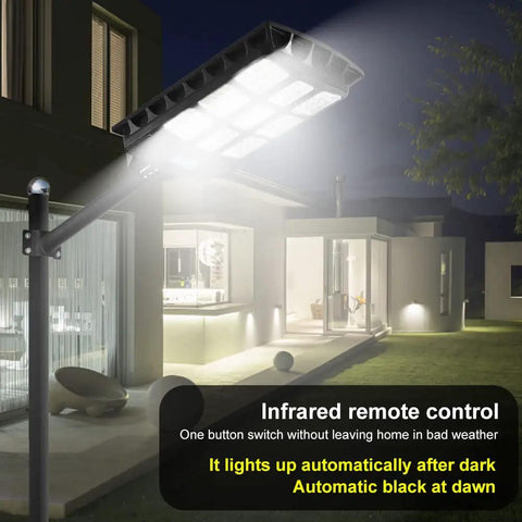 Led Solar Street Light Outdoor Waterproof 50000LM Super Bright Solar Powered Security Flood Light with Motion Sensor illuminating a driveway at night
