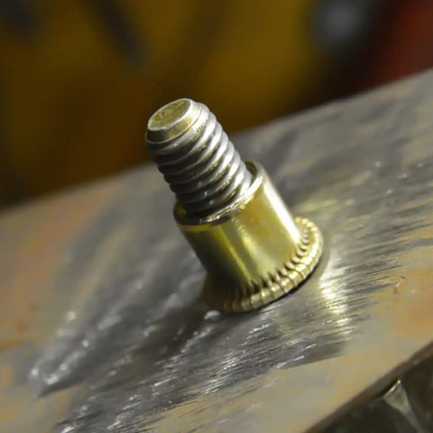 Close-up of a carbon steel rivet nut inserted into metal, part of the Rivet Nuts Assortment Kit 500 Pieces Carbon Steel M3 M4 M5 M6 M8 M10.
