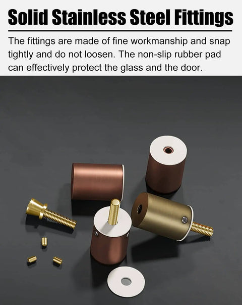 Solid stainless steel fittings with non-slip rubber pads and gold screws on display.