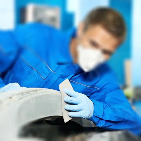 Person using 18 Piece Wet And Dry Sandpaper Set Pro Grade 3000 5000 7000 Grit for Auto Body and DIY Finishing on car surface