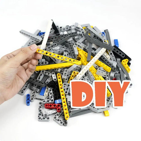 Hand holding yellow beam from 582 Piece Dope Tech Parts Set With Beams Axles Connectors Pins Panels For Building Blocks And Robot Kits