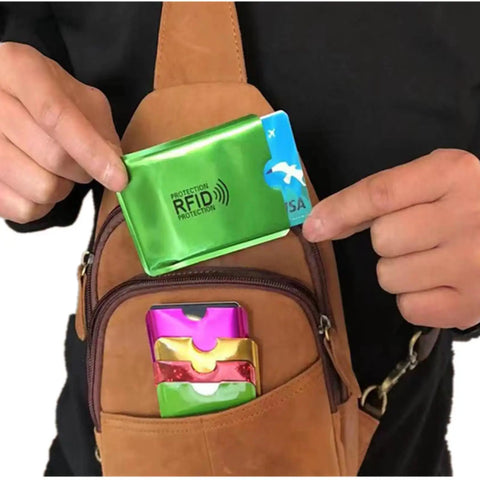 Person using 16 Piece RFID Blocking Sleeve Set with 12 Colorful Credit Card Protectors and 4 Passport Holders in a backpack pocket.