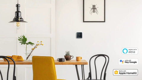Smart Thermostat T5 Black ENERGY STAR Certified in modern dining room with chairs, table, and wall art, compatible with Alexa and HomeKit.