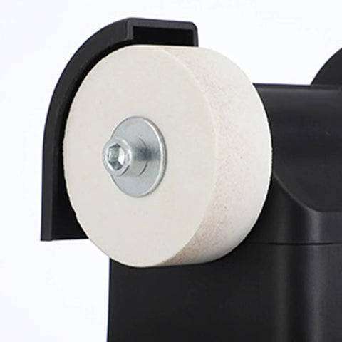 Close-up of the fine abrasive wheel on the Real Badass Compact Dual Wheel Mini Bench Grinder for tool edge sharpening.