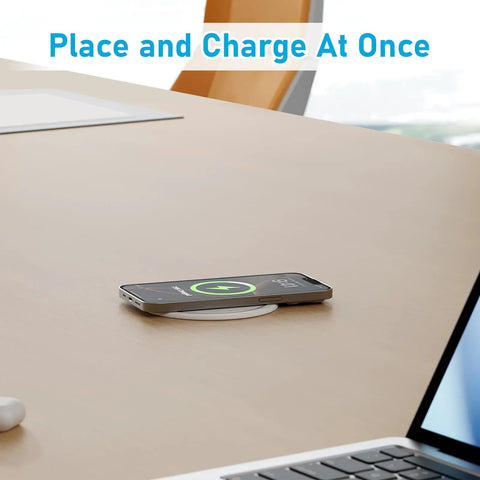 Slick Flush Mount Pop Up Socket Drops Straight Into Countertops Featuring Qi2 Magnetic Wireless Charger With 65W Fast Charging Double Usb Ports Zero Hassle Setup In Fresh White with smartphone charging on desk.