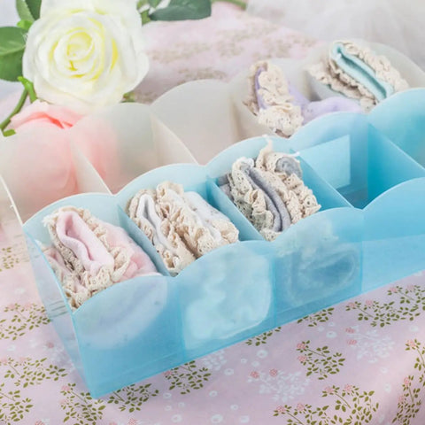 Keep Your Dresser Slick With This Heavy Duty Stackable Underwear Organizer Box Featuring Five Secure Grid Dividers For Neat Sock And Undergarment Storage Drawer showing neatly organized socks in a blue plastic tray.
