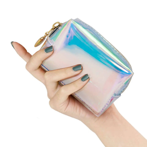 Person holding a small holographic purse-sized Everyday Mini First Aid Kit For Women And Moms, Compact Purse Emergency Kit With 27 Essentials.