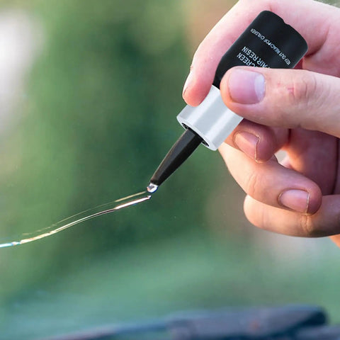 Close-up of No Fuss Windshield Crack Repair Kit for Chips and Small Cracks being applied on automotive glass with nano resin.