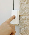Hand pressing button on Wireless Warehouse Doorbell Kit With Flashing Strobe For Noisy Industrial And Residential Environments Loud Entry Alert