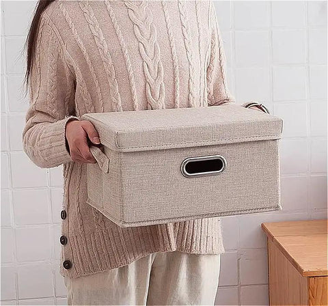 Heavy Duty Fabric Storage Bins With Snap On Lids Stackable Khaki Storage Boxes held by a person in a sweater.