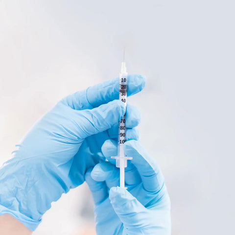 Hands holding 100 Pack 1ml Syringe With 30G 5 By 16 Inch 8mm Needle Individually Wrapped Lab Syringes For Precise Dosing