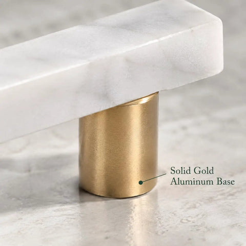 Close-up of Straight Up Premium White Marble Cabinet Pulls With Slick Gold Aluminum Drawer Handles, highlighting gold base.