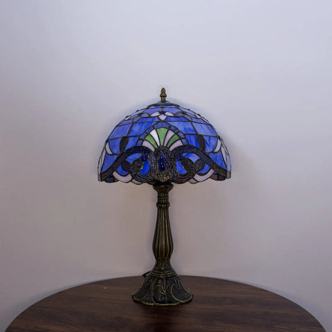 Blue Tiffany Style Table Lamp with handcrafted stained glass and bronze finish on a wooden nightstand, 18 inch tall UL certified.