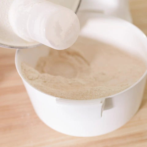 High Speed Grain Mill With 1200 Watt Motor Delivers Fresh Flour Fast No Fuss Milling Quiet Operation And 5 Cups Per Minute Output, Superior Texture Control, Cool Milling To Preserve Nutrients, Durable Milling Heads For Longer Life pouring flour into bowl