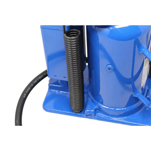 Close-up of a blue massive twenty ton air hydraulic bottle jack with a spring and hose attachment for precision operation.