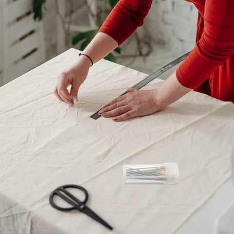 Person using Top Shelf Cross Stitch Needles Set With Quick Threading Aid And Compact Storage Box for sewing on fabric.