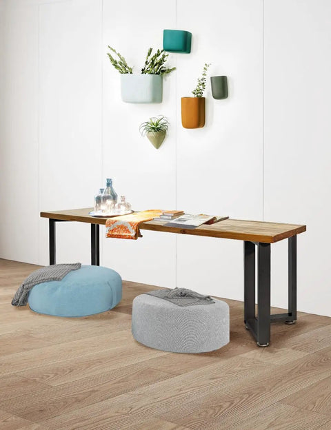 Wooden table with Heavy Duty Iron Dining Table Legs 16 Inch V Shape Black For DIY Tables And Desks, decorated with poufs and plants.