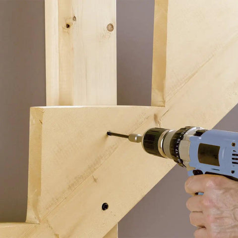 Person drilling with 4 Inch Timber Framing Nails 250 Count Pro Grade Heavy Duty ACQ Safe And Corrosion Resistant Tapered Head