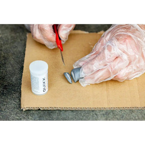 Hands with gloves mixing components of Solid Alloy Wheel Repair Kit For Black Rims DIY liquid aluminum compound.