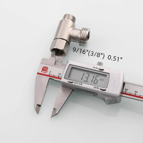 Three Eighths Inch And One Half Inch Stainless Steel Tee Connector With Fittings Nickel Brushed Finish beside measuring caliper