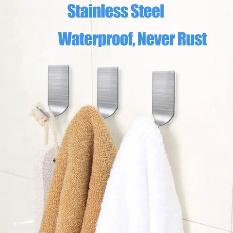 Three stainless steel waterproof adhesive hooks holding towels, showcasing Stick On Hat Hooks For Wall Baseball Cap Rack.