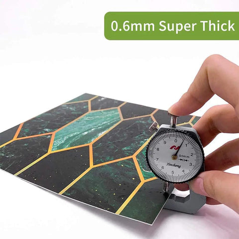 Close-up of caliper measuring thickness of Holographic Emerald Art Deco Peel And Stick Backsplash Tiles Self Adhesive PVC Wall Tiles.