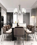 Traditional 5 Light Chandelier In Brushed Nickel With Clear Glass Shades hanging over a modern dining table and chairs