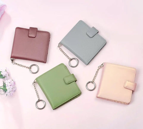 Four slim womens bifold wallets with 9 card slots, RFID blocking, ID window; colors include rose, grey, green, and peach.