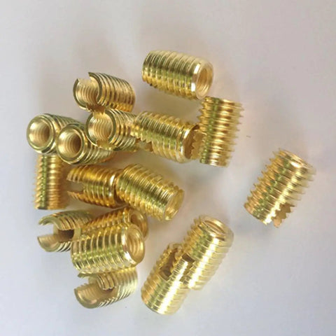 Solid Slotted Thread Repair Kit M3 Includes 50pcs Carbon Steel Self Tapping Inserts Bolt Rethreading Tool Set For Easy Fastener Installation And Durable Screw Fixes On Worn Threads. M3 carbon steel threaded inserts laid out on white background