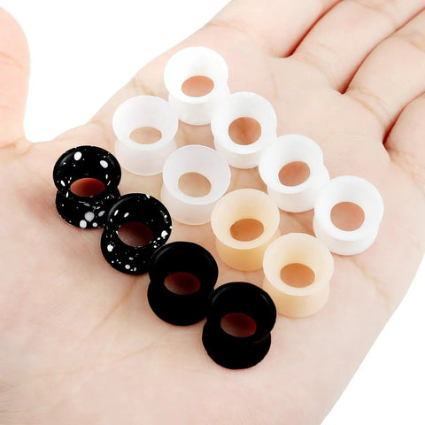 Hand holding Silicone Ear Gauges Tunnels Plugs For Ears Black 8mm 0G 0 Gauge Stretching Kit For Guys And Gals Double Gauge Retainer