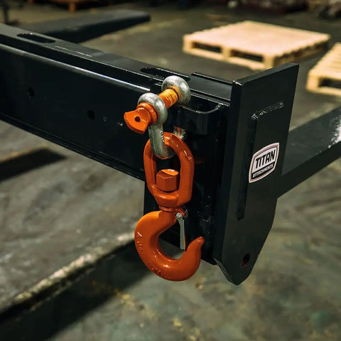 Close-up of Top Shelf Adjustable Fork Spreader For Forklift And Telehandler showing orange hook attachment on black frame.