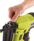Hand adjusting Airstrike 18V Cordless Brad Nailer P320 One Plus Lithium Powered, showing depth dial and nail chamber.