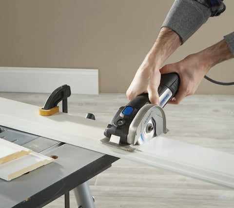 Ultra Saw Corded Compact Saw Tool Kit with 3 cutting wheels and auxiliary handle in use for flush cutting on wood surface
