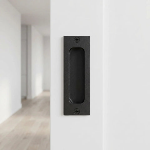 Black stainless steel flush door pull handle on door, part of Two Pack Recessed Finger Flush Door Pulls For Pocket And Sliding Barn Doors.