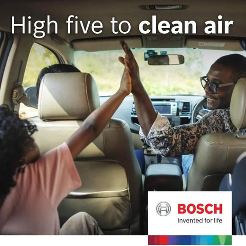 Family in car high-fiving, promoting clean air with Bosch cabin air filters.