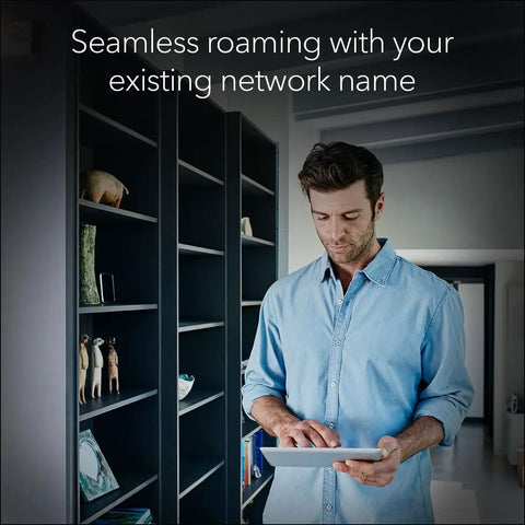 Man using tablet with WiFi 7 Range Extender EXS27 That Covers Up To 1,500 Sq Ft And 45 Devices With BE5000 Dual Band Booster